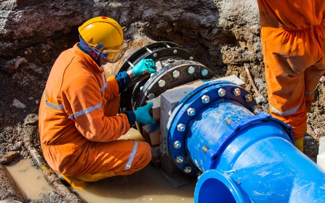 Workers setting up a large new pipe