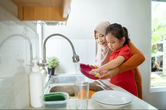 Woman and child washing up